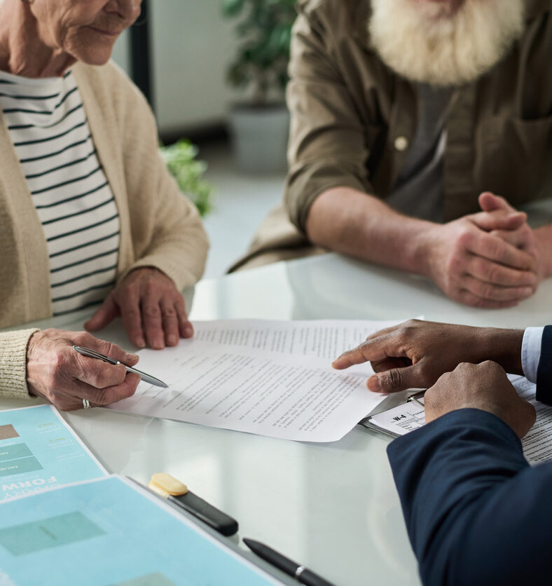 Senior Couple Signing Documents For Pension